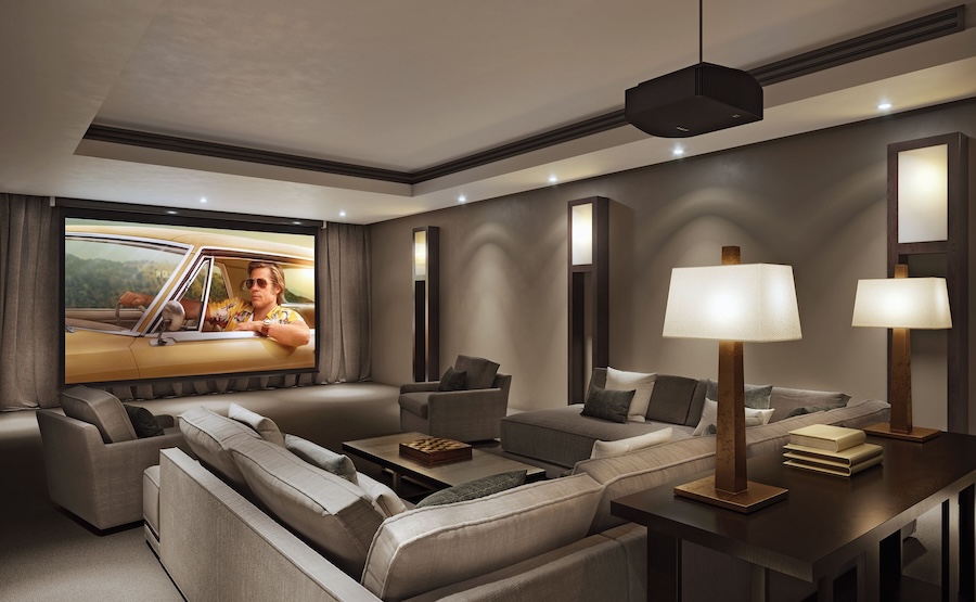 Luxurious home theater with cozy gray sectional seating, ambient lighting, and a large projector screen showing a movie.