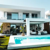 outdoor pool area with covered patio, backyard AV system, and premium lighting