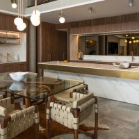 a luxury kitchen with a marble island and walnut cabinetry.