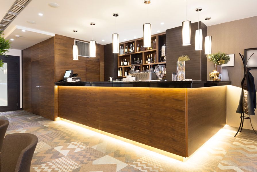 In-ceiling speakers in a hotel bar area.